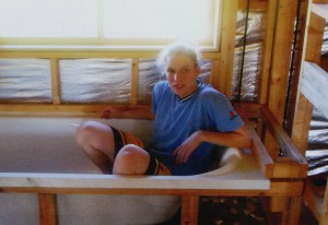Under construction: Jessica Rogers sitting within the framework of her new bathroom.