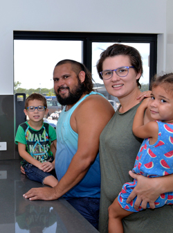 Edward and Sophie with their two children in the kitchen of their new home