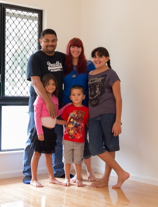 The McGinness family pictured inside the house they have constructed in Far North Queensland.