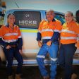 Picture of smiling family in front of vehicle